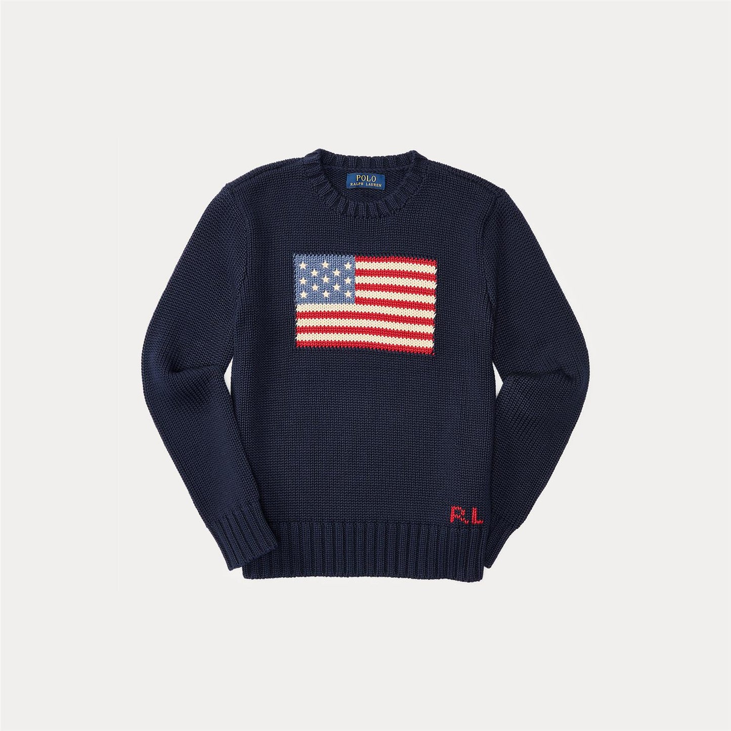 Strikket mørkeblå genser fra Ralph Lauren med amerikansk flagg på brystet. 100% bomull. Passer gutter 2–7 år.