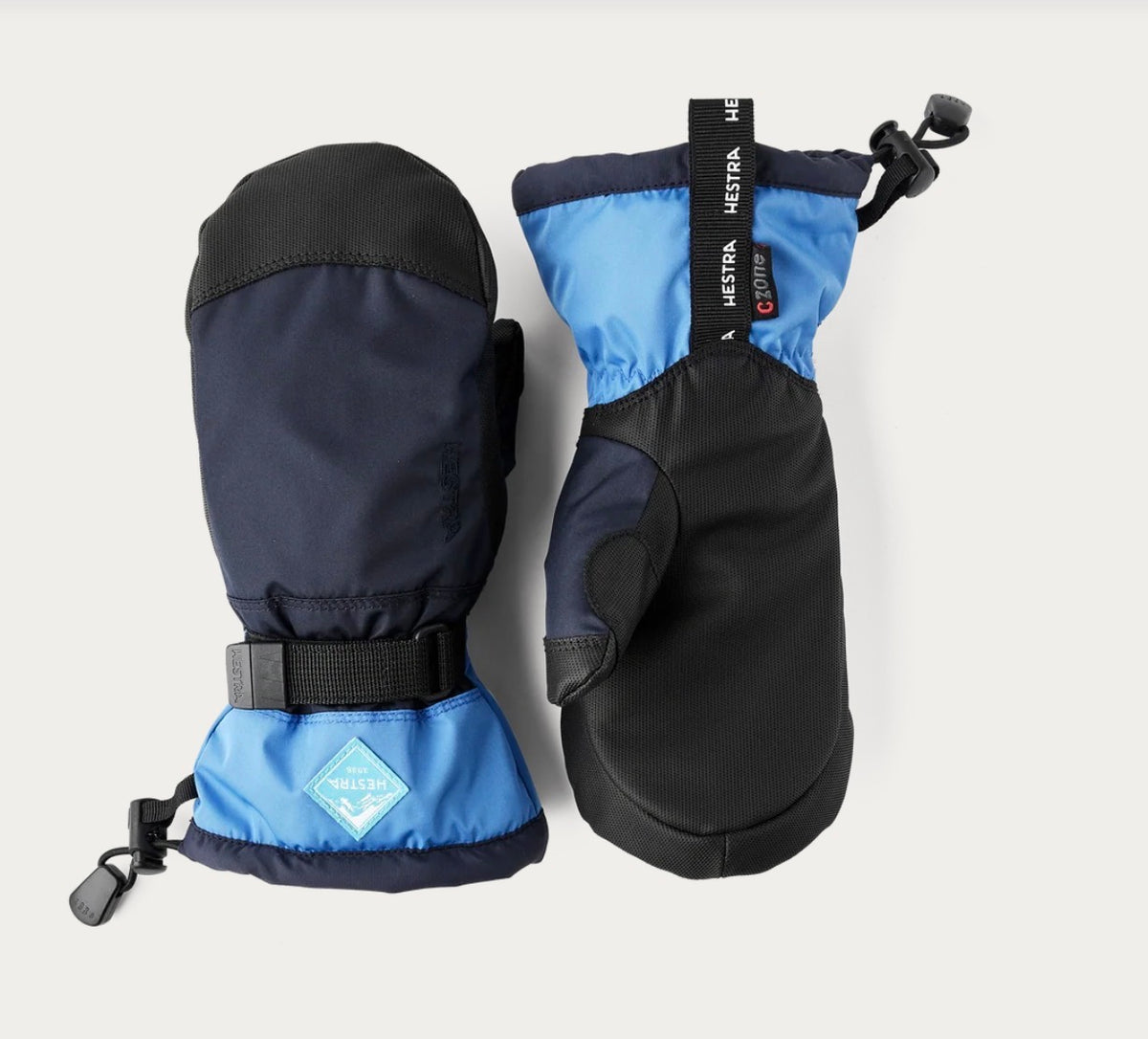 Hestra Gauntlet CZone Jr votter i Navy/Sky blue med svart håndflate, vist som par.